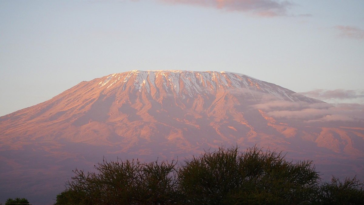 Mount Kilimanjaro at dawn above the clouds